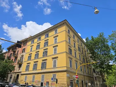 a yellow building on the corner of a street at Dandolo Top Floor Trastevere in Rome