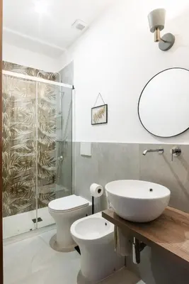 a bathroom with a sink and a toilet and a shower at Le Stanze di Margot con Parcheggio Privato in Rome