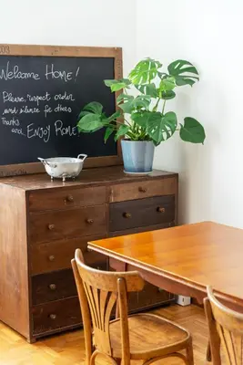 a dining room table with a potted plant on a dresser at Le Stanze di Margot con Parcheggio Privato in Rome