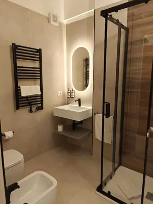 a bathroom with a sink toilet and a mirror at Lilla Eco House - Vaticano in Rome