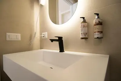 a bathroom with a white sink and a mirror at Lilla Eco House - Vaticano in Rome