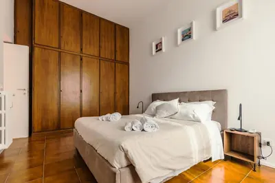 a bedroom with a large bed with towels on it at Domus Merulana 209 Colosseum Apt in Rome