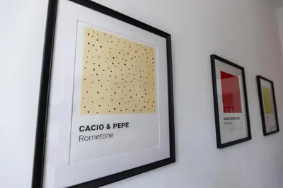 a framed picture of gold dots on a wall at Domus Merulana 209 Colosseum Apt in Rome