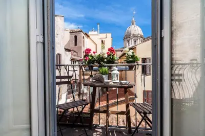 a balcony with a table and chairs and a building at Boutique Domus Navona Librari Balcony in Rome