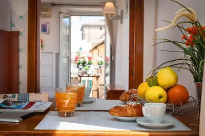 a table with a tray of fruit and drinks on it at Boutique Domus Navona Librari Balcony in Rome