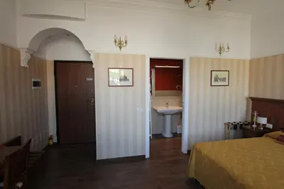 a bedroom with a bed and a sink in a room at Area Sacra Relais in Rome