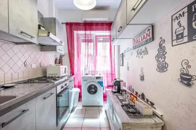 a kitchen with a washer and dryer in it at Margot Appia's dream in Rome