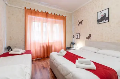 a hotel room with two beds and a window at Margot Appia's dream in Rome