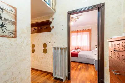 a room with a mirror and a bedroom with a bed at Margot Appia's dream in Rome