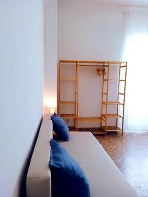 a bed in a room with blue pillows on it at Domus Remo Room #3 in Rome