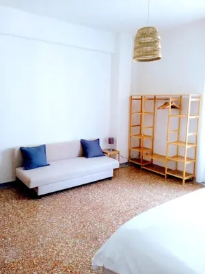 a living room with a couch and a shelf at Domus Remo Room #3 in Rome
