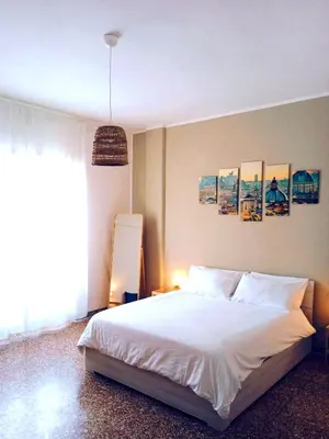 a bedroom with a white bed and a large window at Domus Remo Room #3 in Rome