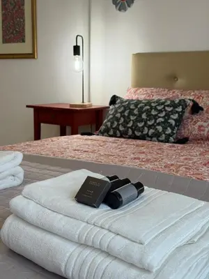 a pile of towels sitting on top of a bed at Vatican Family House Metro A - Rome Collection in Rome