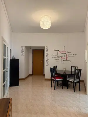 a dining room with a black table and chairs at Vatican Family House Metro A - Rome Collection in Rome
