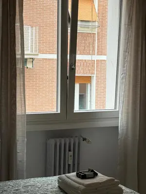 a window with a towel on a table next to a radiator at Vatican Family House Metro A - Rome Collection in Rome
