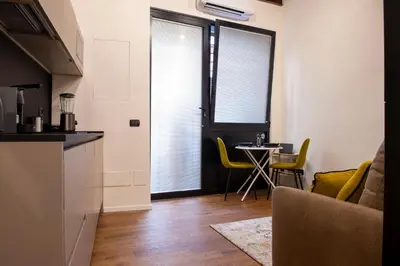 a kitchen with a table and yellow chairs in a room at Maison Ametie in Rome
