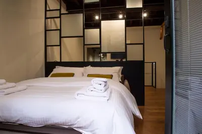 a bedroom with a white bed with towels on it at Maison Ametie in Rome