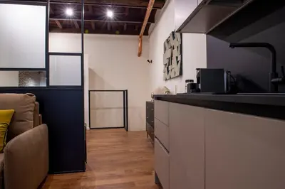 a kitchen with a counter and a couch in a room at Maison Ametie in Rome