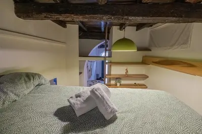 a bedroom with a bed with a towel on it at Loft bohémien a Trastevere in Rome