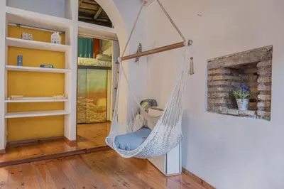 a hammock hanging from a wall in a room at Loft bohémien a Trastevere in Rome