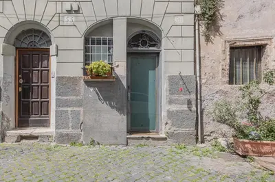 a building with a door and a window and plants at Loft bohémien a Trastevere in Rome