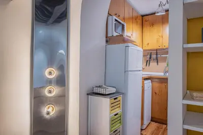 a kitchen with a refrigerator and a microwave at Loft bohémien a Trastevere in Rome