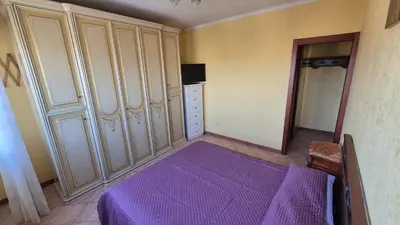 a bedroom with a purple bed and cabinets at Panorama San Paolo in Rome