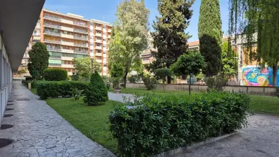 a park with trees and bushes and a building at Panorama San Paolo in Rome