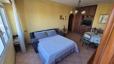 a bedroom with a bed and a table and a television at Panorama San Paolo in Rome