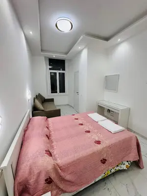 a bedroom with a large bed with a pink blanket at Acropoli in Rome