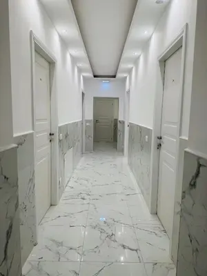 a hallway with marble floors and white walls at Acropoli in Rome