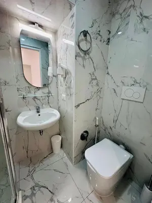 a white bathroom with a toilet and a sink at Acropoli in Rome