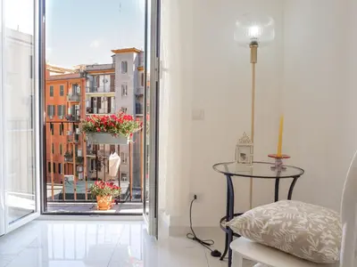 a room with a table and a window with a view at De Camillis Apartments in St Peter in Rome