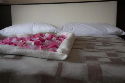 a bunch of pink flowers on a bed at Stardust Rome Guest House in Rome