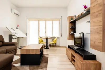 a living room with a couch and a tv and a table at Vatican Giuliano’s House in Rome