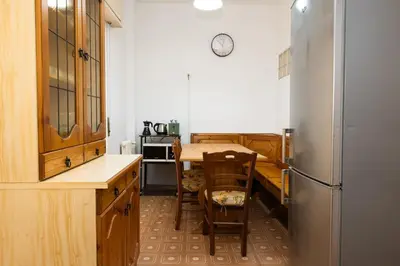 a kitchen with a table and a refrigerator at Vatican Giuliano’s House in Rome