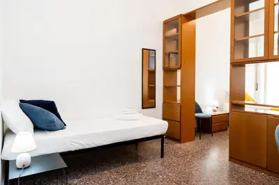 a bedroom with a white bed and a mirror at Vatican Giuliano’s House in Rome