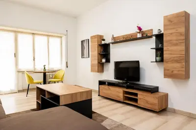 a living room with a television and a table at Vatican Giuliano’s House in Rome