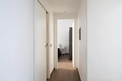 a hallway with white walls and an open door at Casa Simone - The Italian Stay Collection in Rome