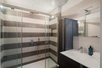 a bathroom with a sink and a glass shower at Casa Simone - The Italian Stay Collection in Rome