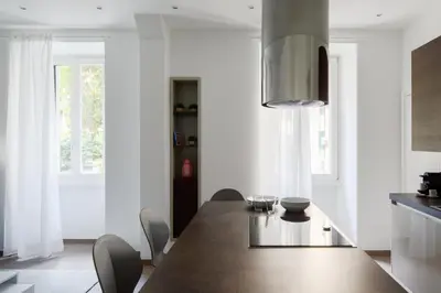 a dining room with a wooden table and chairs at Casa Simone - The Italian Stay Collection in Rome