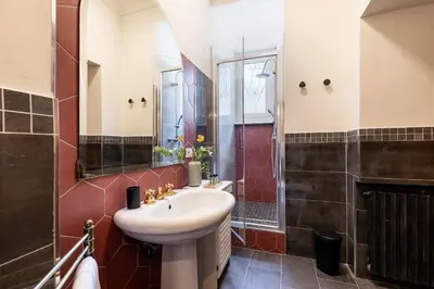 a bathroom with a sink and a shower at Rome As You Feel - Argentina Luxury Apartment in Rome