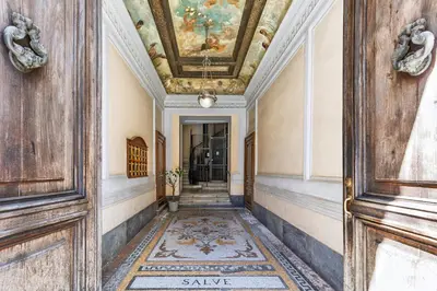 an ornate hallway with a painting on the ceiling at Rome As You Feel - Argentina Luxury Apartment in Rome
