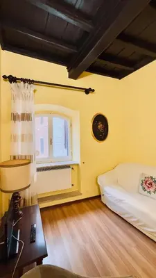 a small room with a bed and a window at Historic apartment by the Pantheon in Rome
