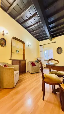 a living room with a table and a mirror at Historic apartment by the Pantheon in Rome