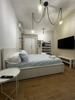 a bedroom with a bed and a flat screen tv at Olimpia Love Apartament in Rome