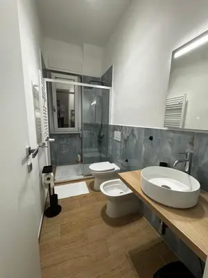 a bathroom with two sinks and two toilets at Olimpia Love Apartament in Rome