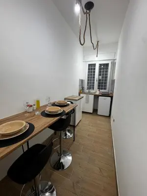 a kitchen with a table and chairs in a room at Olimpia Love Apartament in Rome