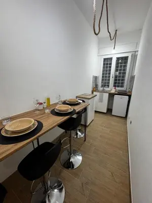a kitchen with a table with plates on it at Olimpia Love Apartament in Rome