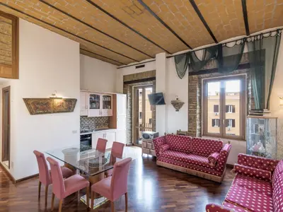a living room with a glass table and red chairs at Apartment Lucilla Home by Interhome in Rome